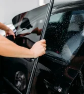 Professional Window Tinting by Exclusive Car Care – UV Protection & Privacy Car window being professionally tinted by Exclusive Car Care for UV protection and privacy