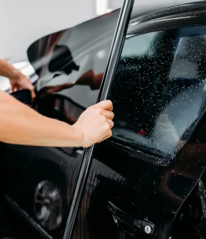Car window being professionally tinted by Exclusive Car Care for UV protection and privacy