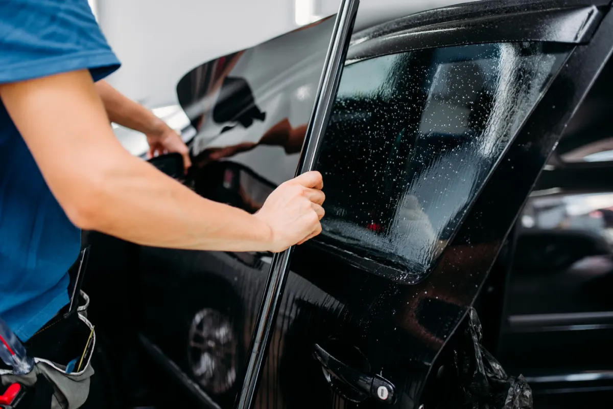 Car window being professionally tinted by Exclusive Car Care for UV protection and privacy